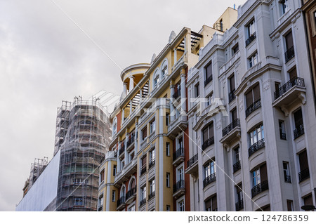 Scenic view of Madrid skyline on Gran Via street reveals ornate buildings and construction. 124786359
