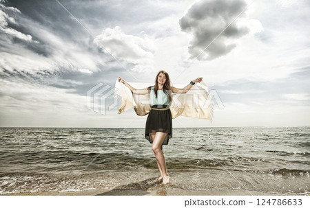 young beautiful woman portrait on the beach 124786633