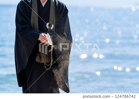 An image of ocean scattering where monks hold a memorial service in the sea 124786742