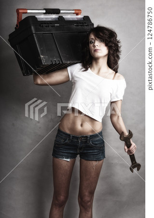 Sexy girl holding toolbox and wrench spanner Sexy girl holding toolbox and wrench spanner 124786750