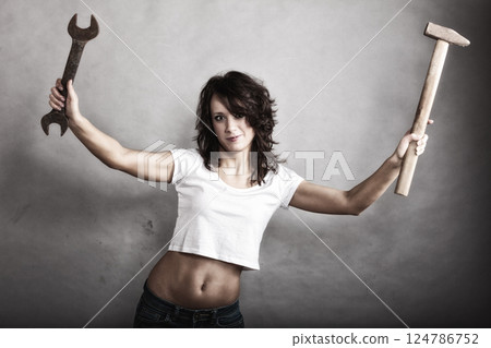 Sexy girl holding hammer and wrench spanner 124786752