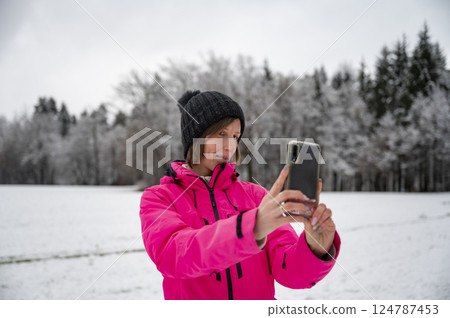 Woman taking a selfie in a snowy landscape 124787453