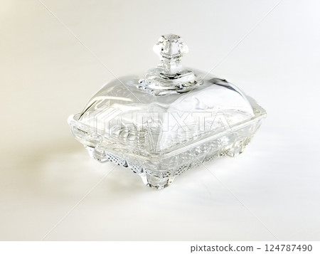 Glass container for storing butter on white background. Glass container for storing butter on white background. 124787490