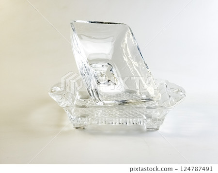 Glass container with lid for storing butter on white background. Glass container with lid for storing butter on white background. 124787491