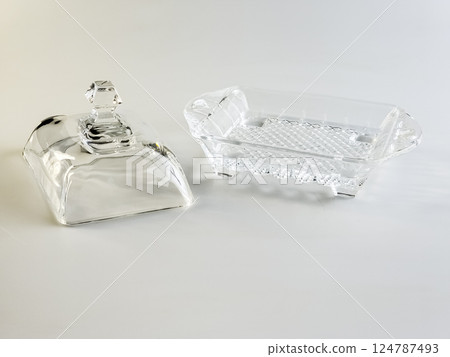 Glass container for storing butter on a white background. 124787493