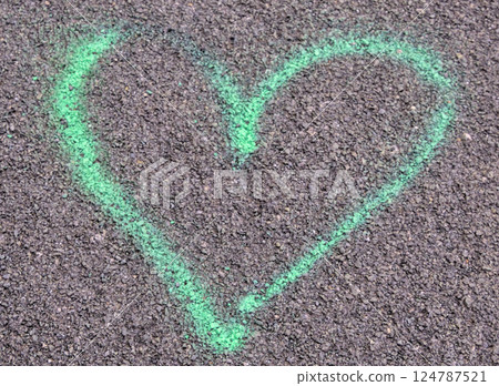 green heart on asphalt 124787521