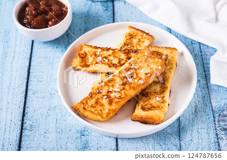 Golden sweet croutons of bread on a plate on the table Golden sweet croutons of bread on a plate on the table 124787656