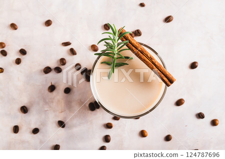 Close up of aromatic coffee with rosemary and cinnamon in a glass on the table top view Close up of aromatic coffee with rosemary and cinnamon in a glass on the table top view 124787696
