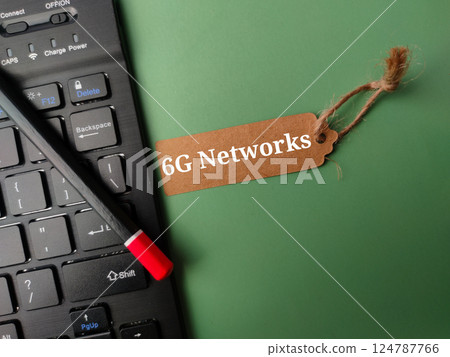 Black keyboard and brown card with the word 6g networks on a green background. 124787766