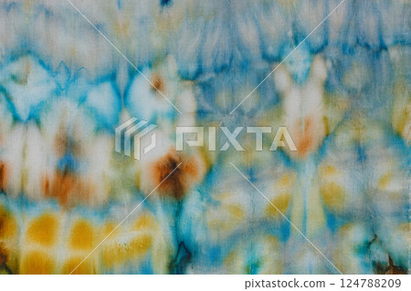 abstract pattern on silk fabric texture in blue, yellow, green colors 124788209