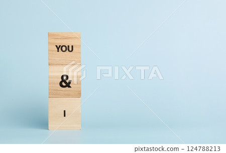 Wooden cubes with inscriptions You And I on a blue background 124788213