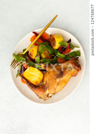 Enjoy a delicious, hearty meal with baked rabbit, roasted potatoes, and carrot salad, combining savory flavors and wholesome ingredients for a nutritious and satisfying dinner Enjoy a delicious, hearty meal with baked rabbit, roasted potatoes, and carrot salad, combining savory flavors and wholesome ingredients for a nutritious and satisfying dinner 124788677