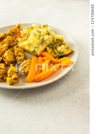 Enjoy a delicious vegetarian meal with fried zucchini flowers in batter, a cauliflower omelette with stewed peppers, perfect for breakfast or lunch Enjoy a delicious vegetarian meal with fried zucchini flowers in batter, a cauliflower omelette with stewed peppers, perfect for breakfast or lunch 124788688