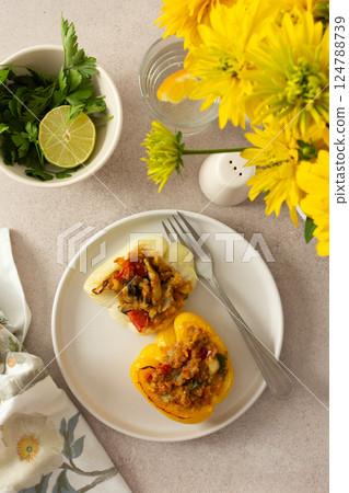 Stuffed bell peppers with quinoa, lentils, and fresh vegetables offer a delicious and healthy breakfast or lunch option, packed with protein, fiber, and vibrant flavors Stuffed bell peppers with quinoa, lentils, and fresh vegetables offer a delicious and healthy breakfast or lunch option, packed with protein, fiber, and vibrant flavors 124788739