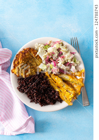 A wholesome and savory breakfast with brown rice and baked white fish, complemented by zucchini-carrot pancakes and a fresh Chinese cabbage salad with radish A wholesome and savory breakfast with brown rice and baked white fish, complemented by zucchini-carrot pancakes and a fresh Chinese cabbage salad with radish 124788743