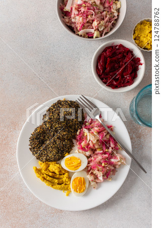 A nutritious breakfast featuring quinoa pancakes, fresh cabbage, radish, mung bean sprouts, boiled eggs, hummus, and roasted beets, perfect for a balanced start to your day A nutritious breakfast featuring quinoa pancakes, fresh cabbage, radish, mung bean sprouts, boiled eggs, hummus, and roasted beets, perfect for a balanced start to your day 124788762