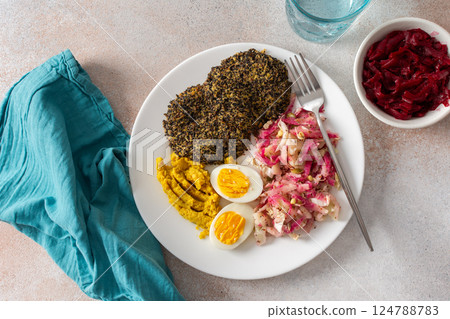 A vibrant, healthy breakfast with quinoa pancakes, crisp cabbage, radish, and mung bean sprouts, complemented by boiled eggs, hummus, and beets for a nutrient-packed meal A vibrant, healthy breakfast with quinoa pancakes, crisp cabbage, radish, and mung bean sprouts, complemented by boiled eggs, hummus, and beets for a nutrient-packed meal 124788783
