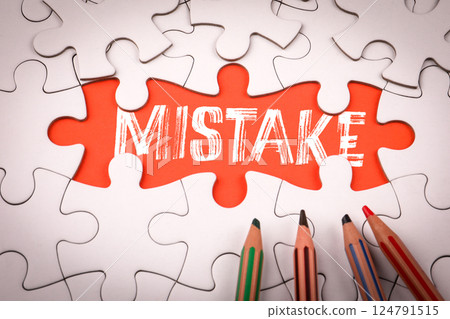 MISTAKE. White puzzle pieces and colored pencils 124791515