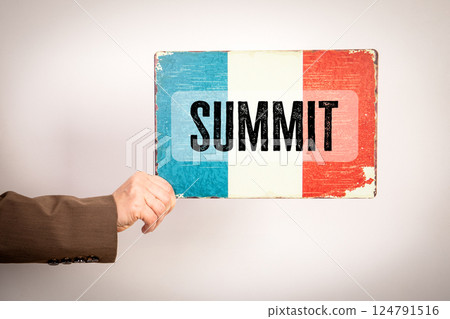 Summit Sign. Flag in a woman's hand on a light background 124791516