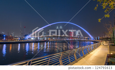 Pedestrian Bridge over the Dubai Water Canal day to night timelapse, United Arab Emirates 124791613