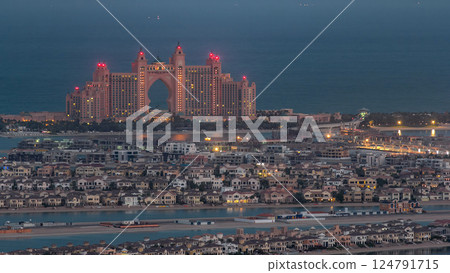 Jumeirah Palm Island night to day timelapse dubai shot from the rooftop top of the tower in dubai marina, uae 124791715