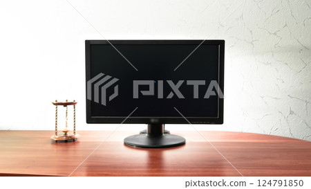 Work desk for digital job with computer, hourglass near the monitor timelapse hyperlapse. 124791850