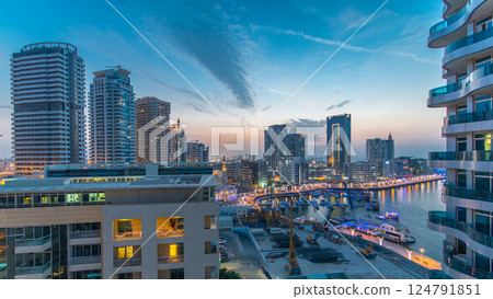An Aerial view of Dubai Marina towers in Dubai day to night timelapse 124791851