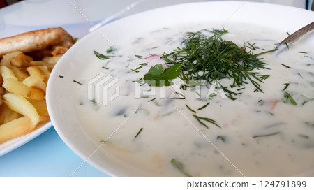 sour milk with dill and cilantro and tomato 124791899