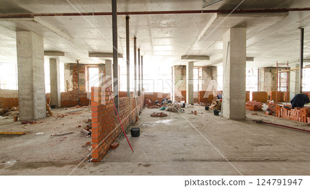 Bricklayers laying bricks to make a walls timelapse. 124791947