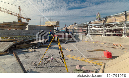 Construction worker using theodolite surveying optical instrument timelapse. 124791958