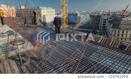 Construction workers working on steel rods used to reinforce concrete timelapse 124791959