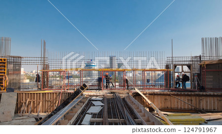 Construction workers working on steel rods used to reinforce concrete timelapse 124791967