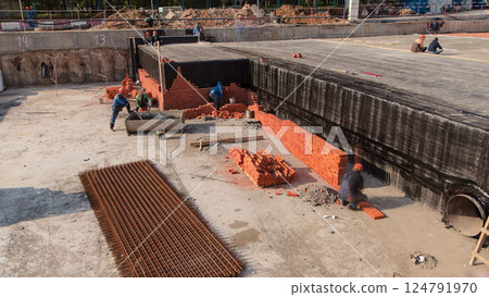 Bricklayers laying bricks to make a walls timelapse. Bricklayers laying bricks to make a walls timelapse. 124791970