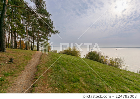 Forest walking path on the lake shore in autumn Forest walking path on the lake shore in autumn 124792008
