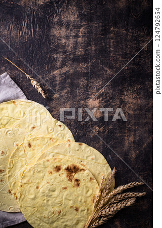 Lavash flat bread on green background 124792654