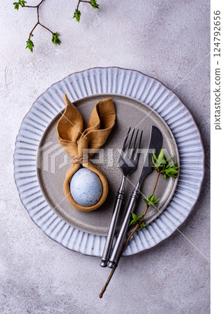 Elegant Easter table setting with painted egg Elegant Easter table setting with painted egg 124792656