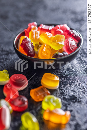 The colorful jelly candies in bowl on black table. The colorful jelly candies in bowl on black table. 124792897