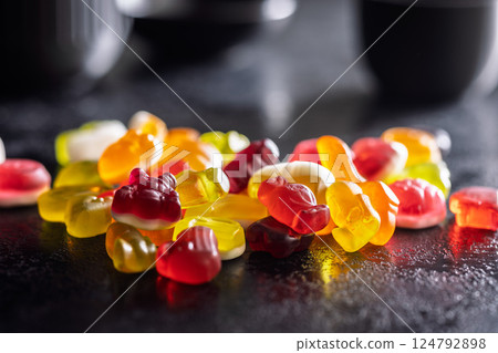 The colorful jelly candies on black table. 124792898