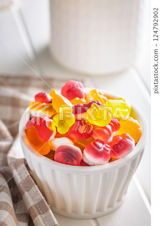 The colorful jelly candies in bowl on white table. The colorful jelly candies in bowl on white table. 124792902