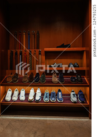 Elegant men's leather shoes on store shelves in mall. Shopping center. Men's clothing store. 124793255