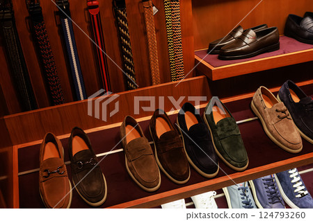 Elegant men's leather shoes on store shelves in mall. Shopping center. Men's clothing store. Elegant men's leather shoes on store shelves in mall. Shopping center. Men's clothing store. 124793260