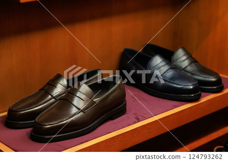 Elegant men's leather shoes on store shelves in mall. Shopping center. Men's clothing store. Elegant men's leather shoes on store shelves in mall. Shopping center. Men's clothing store. 124793262