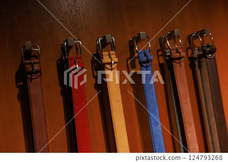 A group of multi-colored leather belts on display. A group of multi-colored leather belts on display. 124793268