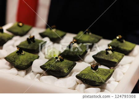 Luxurious matcha-infused dessert with a velvety green coating 124793308