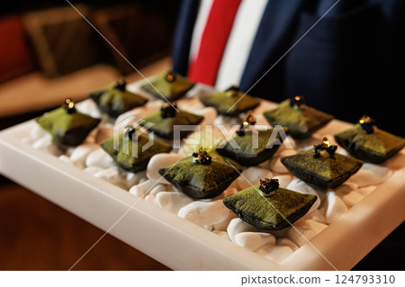 Luxurious matcha-infused dessert with a velvety green coating 124793310