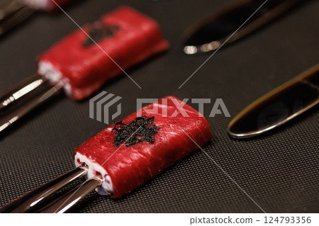 Exquisite gourmet appetizer featuring delicate slices of raw beef wrapped around a creamy filling 124793356