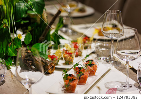 Exquisite gourmet salmon tartare appetizers elegantly presented in clear cups 124793382