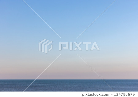 Tranquil seascape with a still blue sea stretching into the horizon Tranquil seascape with a still blue sea stretching into the horizon 124793679