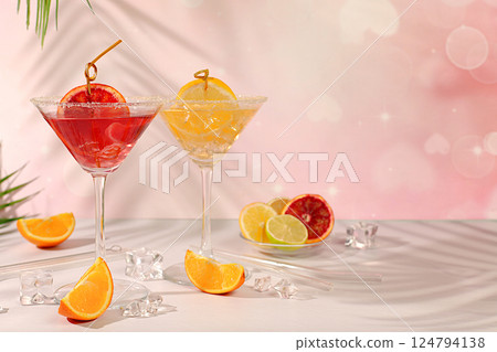 Martini cocktails with lemon and orange, ice cubes, rum and tequila. Summer party and holiday concept. Banner with alcoholic drinks and tropical fruits. Menu for a bar or cafe. Martini cocktails with lemon and orange, ice cubes, rum and tequila. Summer party and holiday concept. Banner with alcoholic drinks and tropical fruits. Menu for a bar or cafe. 124794138