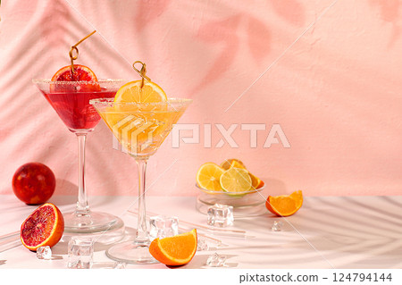 Summer party and relaxation concept. Martini cocktails with lemon and orange, ice cubes, rum and tequila. Banner with alcoholic drinks and tropical fruits. Menu for a bar or cafe. Summer party and relaxation concept. Martini cocktails with lemon and orange, ice cubes, rum and tequila. Banner with alcoholic drinks and tropical fruits. Menu for a bar or cafe. 124794144